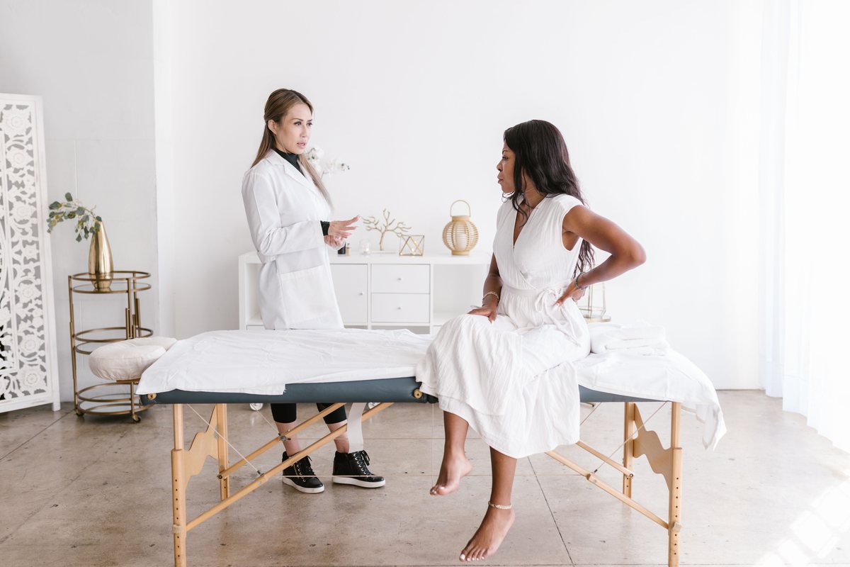 Clinician speaking with a seated client in a treatment room