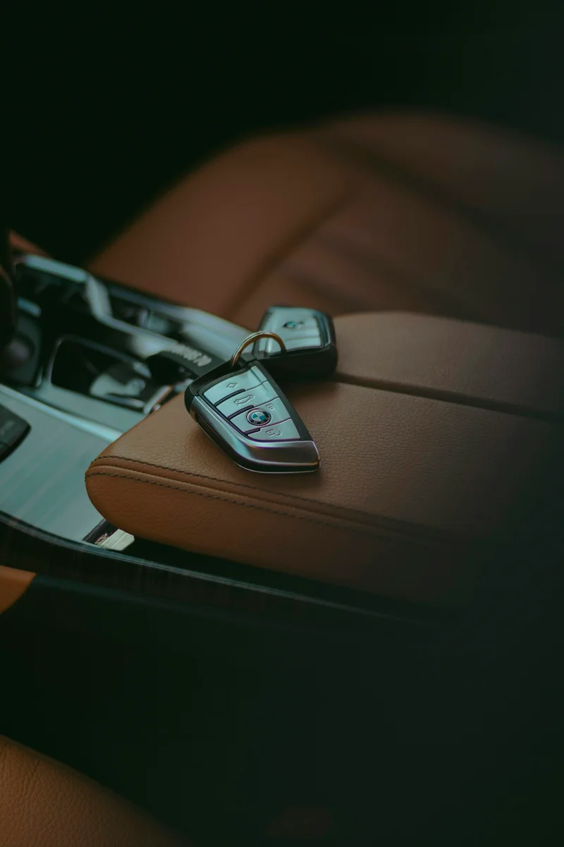 Illustrative stock photograph of a vehicle key fob resting on a car seat